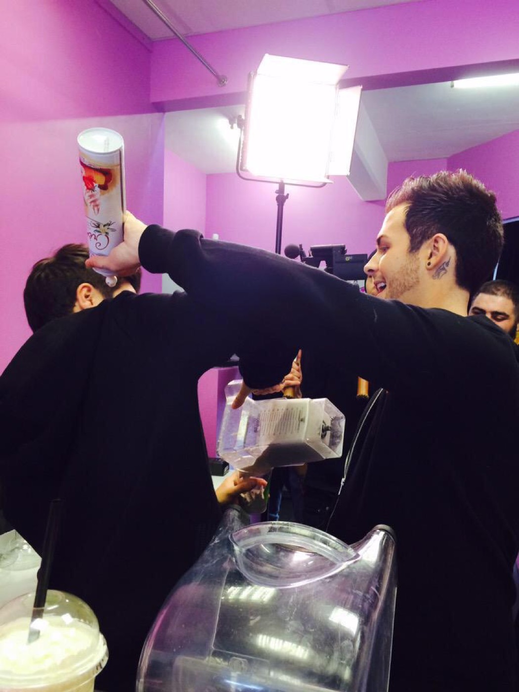 Union J making milkshakes under film lighting during the EA Sims 4 Get to Work launch at Milkshake City