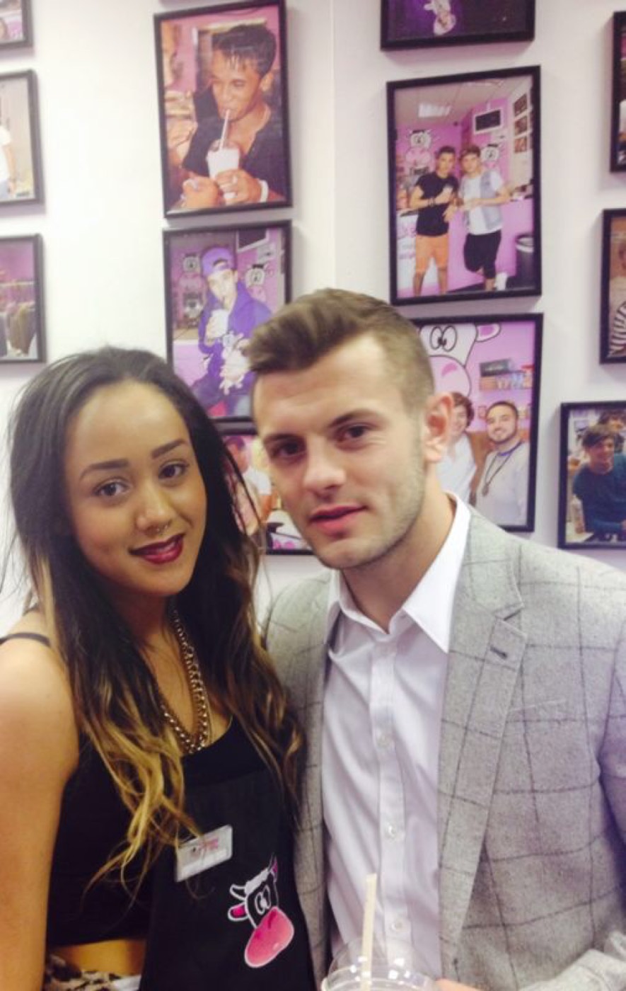 Jack Wilshere with a member of Milkshake City staff, in front of the shop’s wall of framed photographs