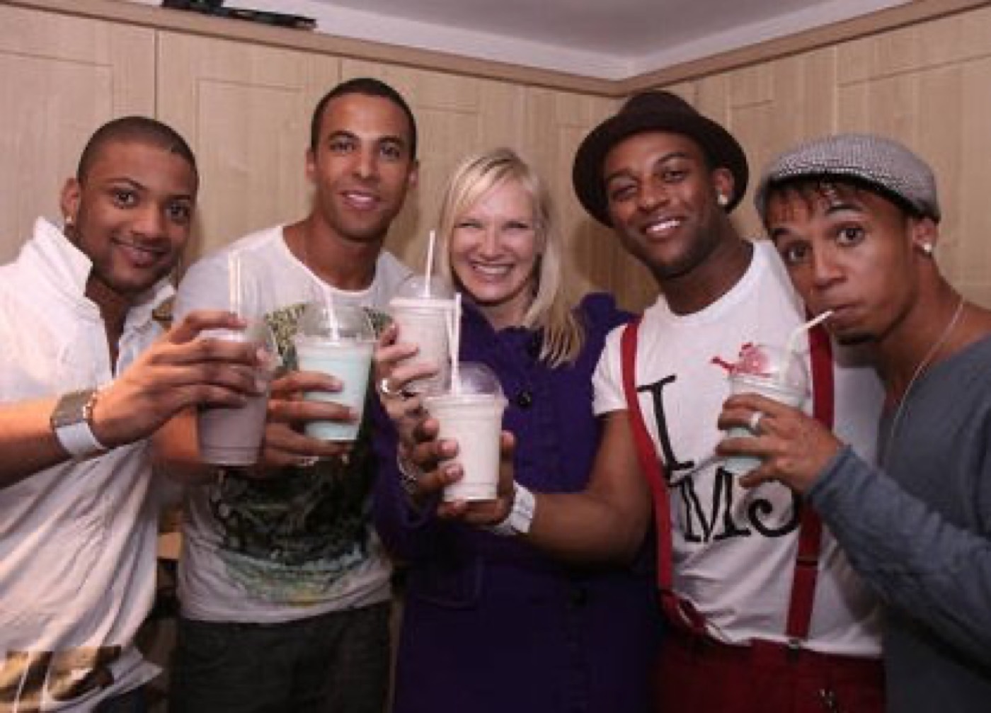 The four members of JLS raising Milkshake City milkshakes