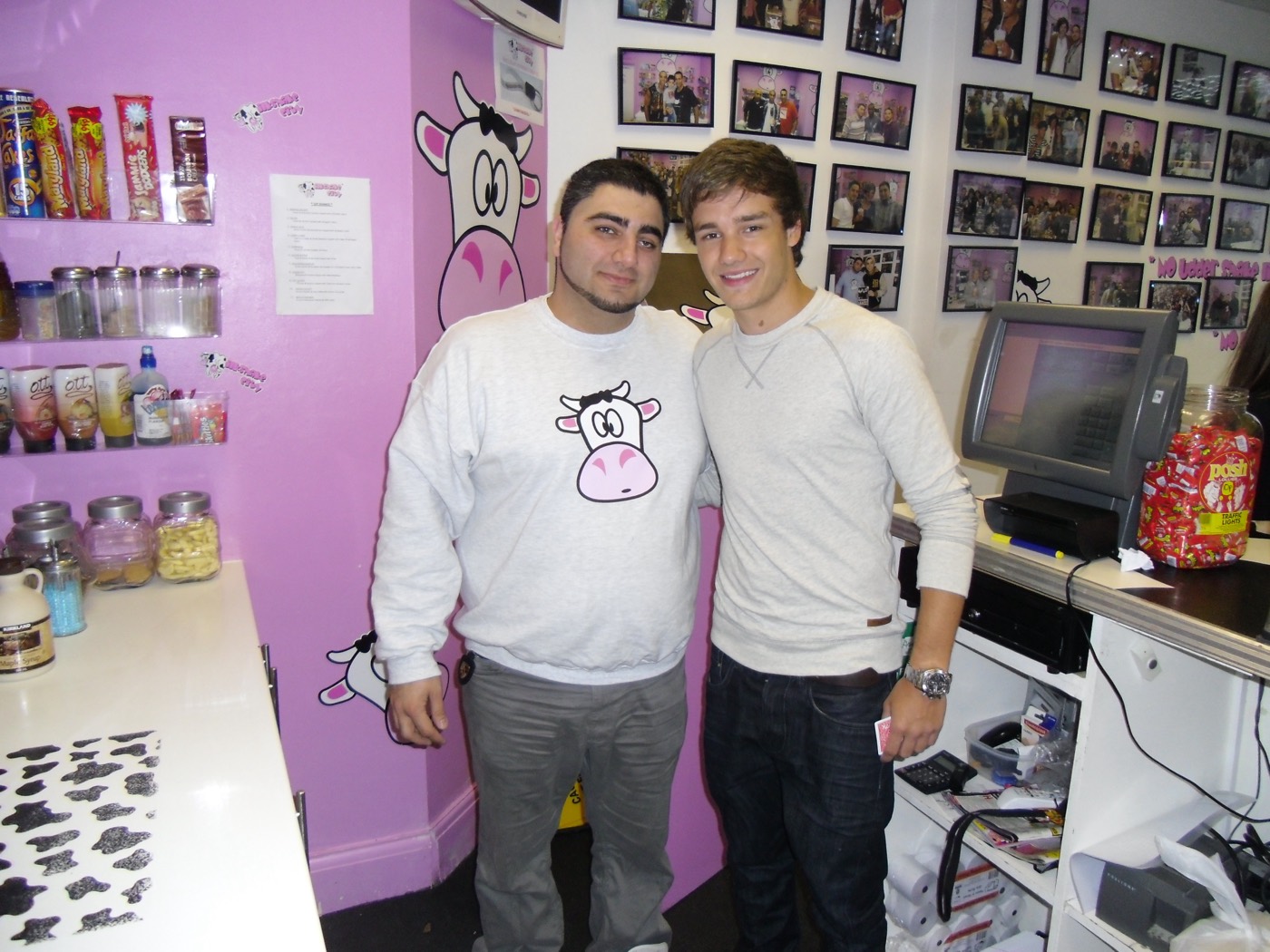 Liam Payne standing with a member of staff at the Milkshake City counter